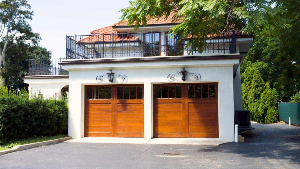 Wooden garage door with installed opener system
